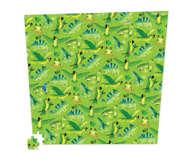 A green puzzle covered in green birds, chameleons and frogs that's slightly larger at the top 