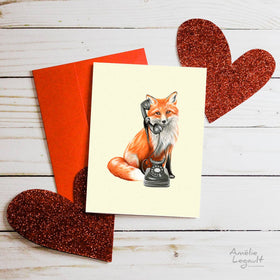 A white card with a fox on a dial phone