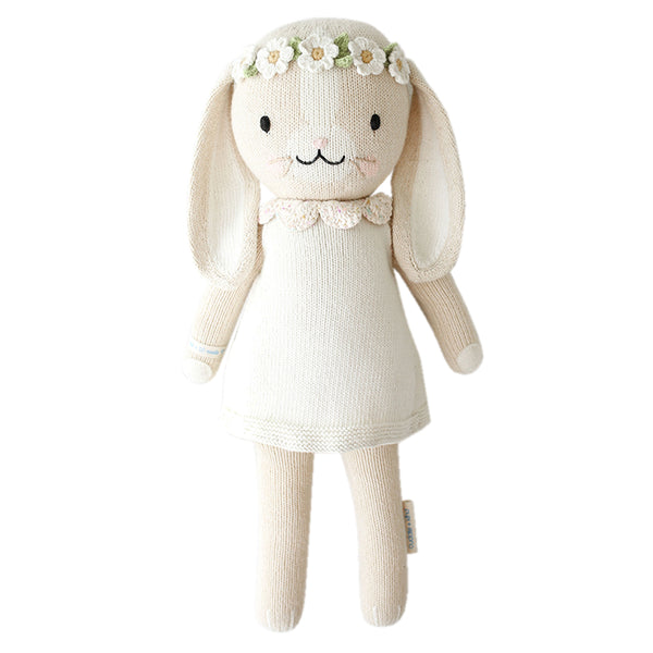  A bunny stuffy wearing a pink dress and flower crown