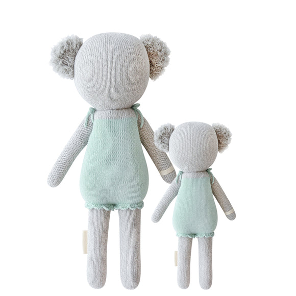 A back shot of the 2 different sized koalas wearing teal dresses