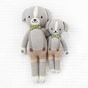  2 different sized dog stuffies wearing beige overalls