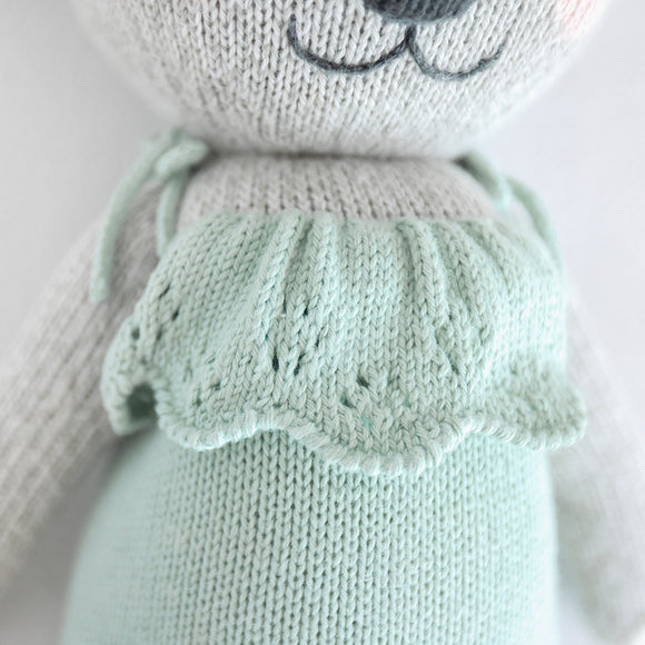 A close up of the teal dress on the koala