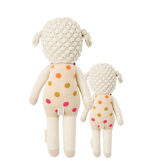 2 different sized lamb stuffies, both in pink polka dot overalls