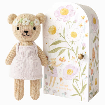 Tiny Olivia the Honey Bear - Handmade knitted honey bear doll wearing pink dress beside floral-themed wooden gift box, unique Canadian toy gift.