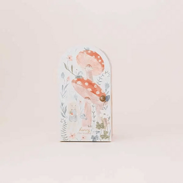 Tiny Henry the Bunny - Arch-shaped wooden plaque with pastel illustration of mushrooms, a bunny, and flowers, featuring soft blush and green tones.