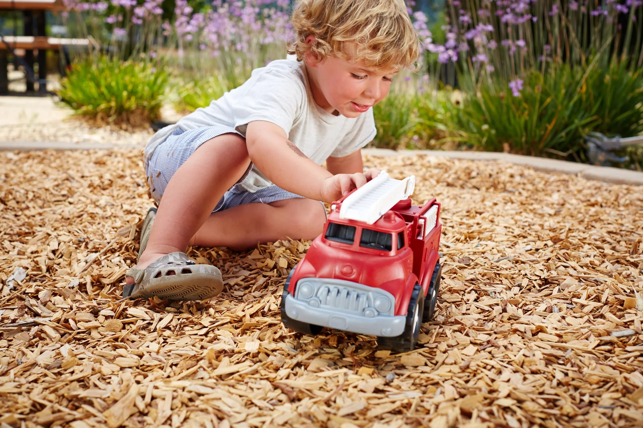 A child playing with Fire Truck (Green Toys)