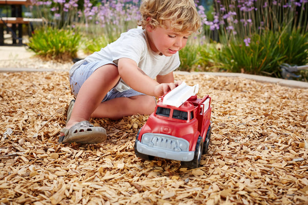 A child playing with Fire Truck (Green Toys)