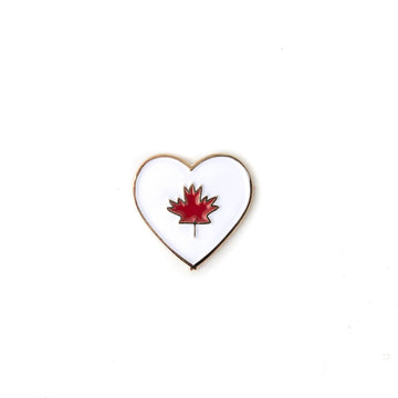 Canada Heart Enamel Pin - Heart-shaped enamel pin with red maple leaf, handmade Canadian gift accessory.