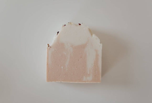 Rosé All Day Soap Bar - Rectangular handmade soap bar with soft pink and white swirls and a textured top edge sprinkled with dried flower petals.