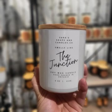 The Junction - 9oz Soy Candle - Handheld 9oz white soy candle with wooden lid, Sara’s Soaps & Candles label, unique Canadian handmade gift.