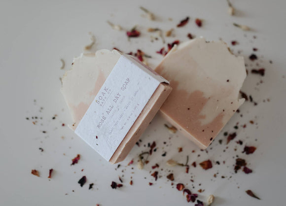 Rosé All Day Soap Bar - Light pink rectangular soap bar with rounded edges, handmade texture, wrapped in white label, surrounded by dried flower.