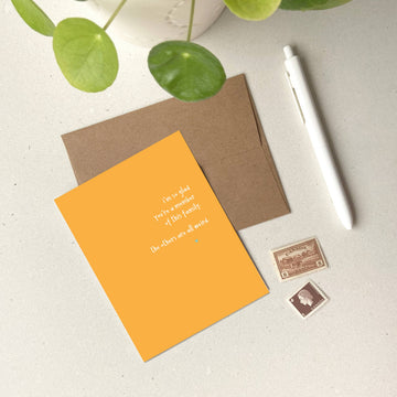 Glad You're a Member of This Family Card - Orange greeting card with white handwritten text, brown envelope, and Canadian stamps, unique handmade gift.