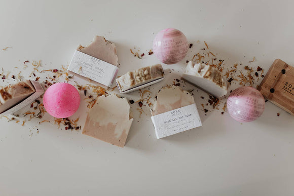 Rosé All Day Soap Bar - Three rectangular handmade soap bars in shades of soft pink and beige with textured tops, accompanied by pink and white bath