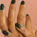 Vegan & 21-free Nail Polish - En Beau Fusil - Hand with dark green matte vegan nail polish on oval nails and delicate gold twisted ring.