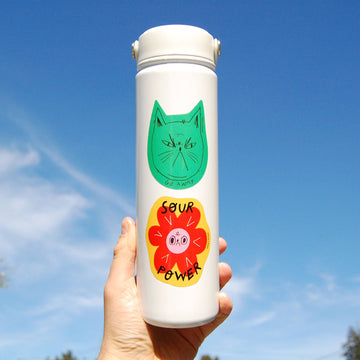 Snitty Kitty "Go Away" Sticker - White cylindrical bottle with green cat face and red flower "Sour Power" stickers, unique handmade Canadian gift.
