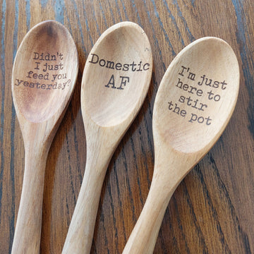 Funny Humor Laser Engraved Wooden Spoon - Three light wooden spoons with laser-engraved humorous phrases on each bowl, rustic kitchen accessory gift.