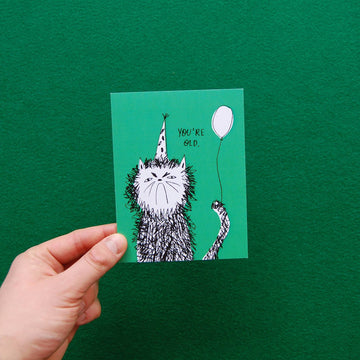 Snitty Kitty Birthday Card - Handmade Canadian birthday card with whimsical black cat in party hat holding white balloon, unique gift design.