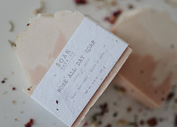 Rosé All Day Soap Bar - Rectangular pale pink handmade soap bar with white label reading Rosé All Day Soap by SOAK Bath Co, sprinkled with dried.