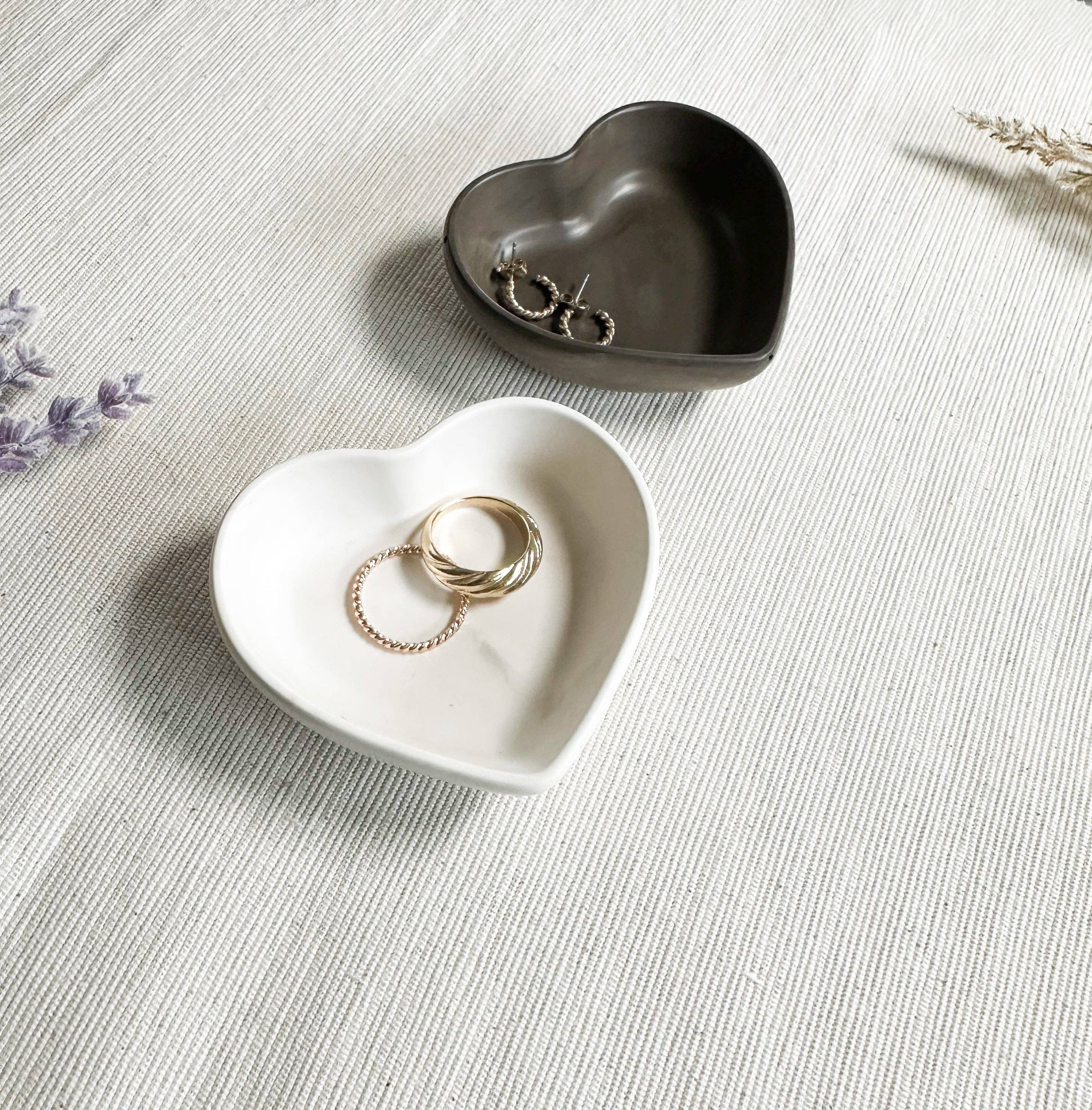 Mini Heart Dish (no tariffs) - Two heart-shaped ceramic dishes in cream and dark gray, perfect for holding jewelry or small items.
