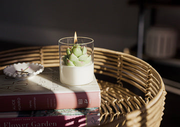 Succulent Soy Candle | Soy Blend - Clear glass candle with a green succulent-shaped soy wax centerpiece on white wax base, lit flame visible.