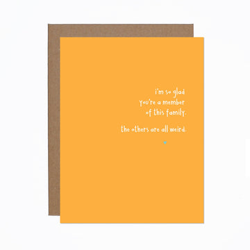 Glad You're a Member of This Family Card - Orange greeting card with white handwritten text and small blue star, paired with a brown envelope, unique handmade Canadian .