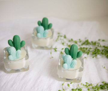 Cactus Tealight Candles | Soy Wax Blend - Set of three handmade Canadian soy wax candles shaped like green cacti in clear square glass holders, perfect unique gift.
