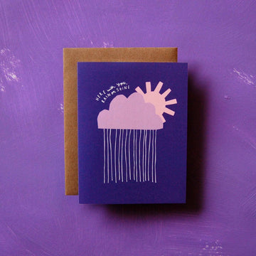 Rain or Shine Card - Purple greeting card featuring a pink cloud with raindrops and a yellow sun partially visible behind the cloud.