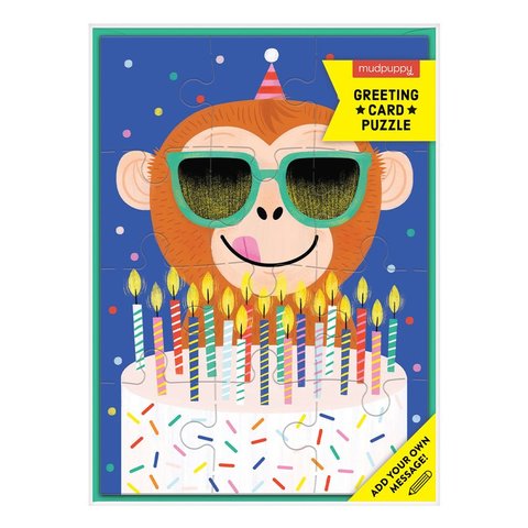 A blue card puzzle with a monkey wearing sunglasses in front of a birthday cake