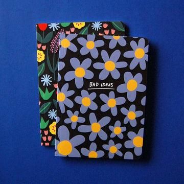 Bad Ideas Notebook - Notebook with black cover featuring large blue and yellow daisies and "Bad Ideas" text in white, rounded corners.
