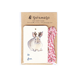 A white gift tag with a bunny facing forward with antlers. Below the bunny is black text reading 