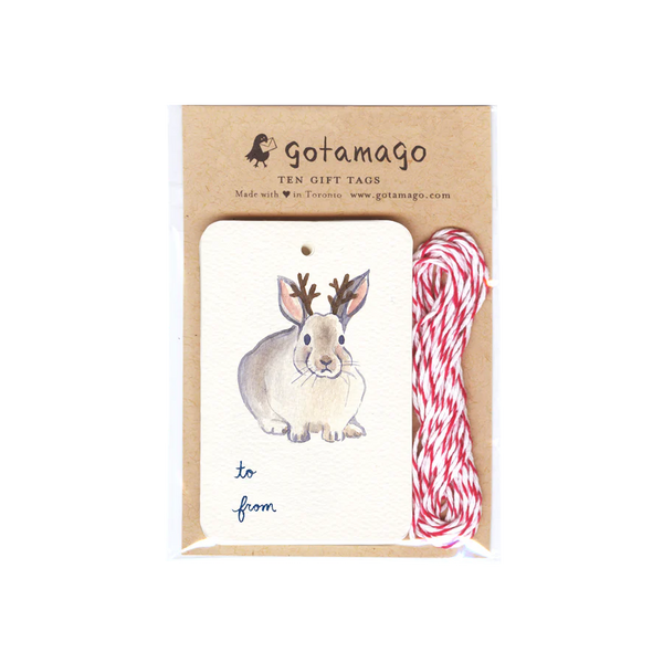 A white gift tag with a bunny facing forward with antlers. Below the bunny is black text reading 