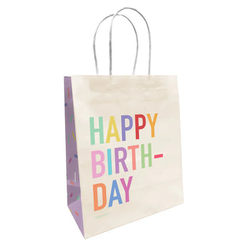 Rainbow Sprinkle Birthday Paper Bag - Handmade Canadian gift bag with colorful rainbow sprinkle "Happy Birthday" text on white background, twisted paper handles.