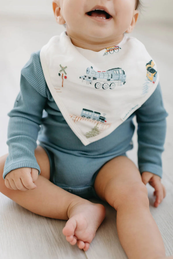 A baby wearing the train patterned bandana bib