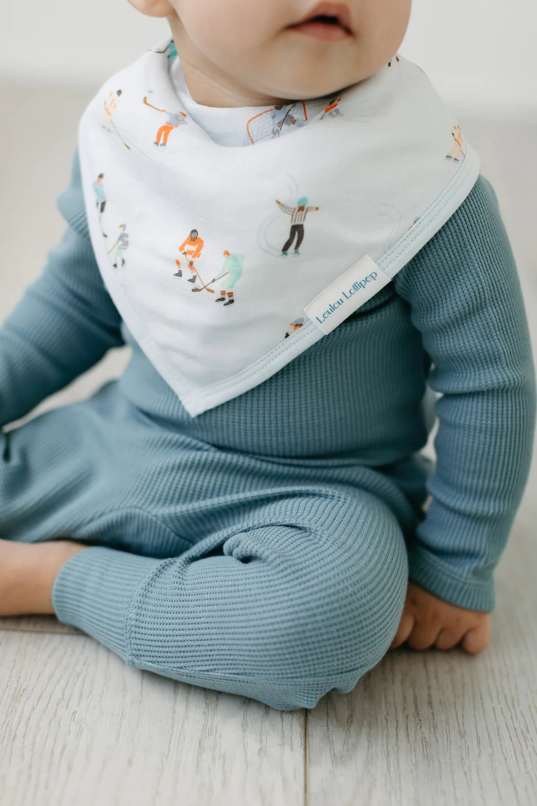 A baby wearing the ice hockey bandana bib