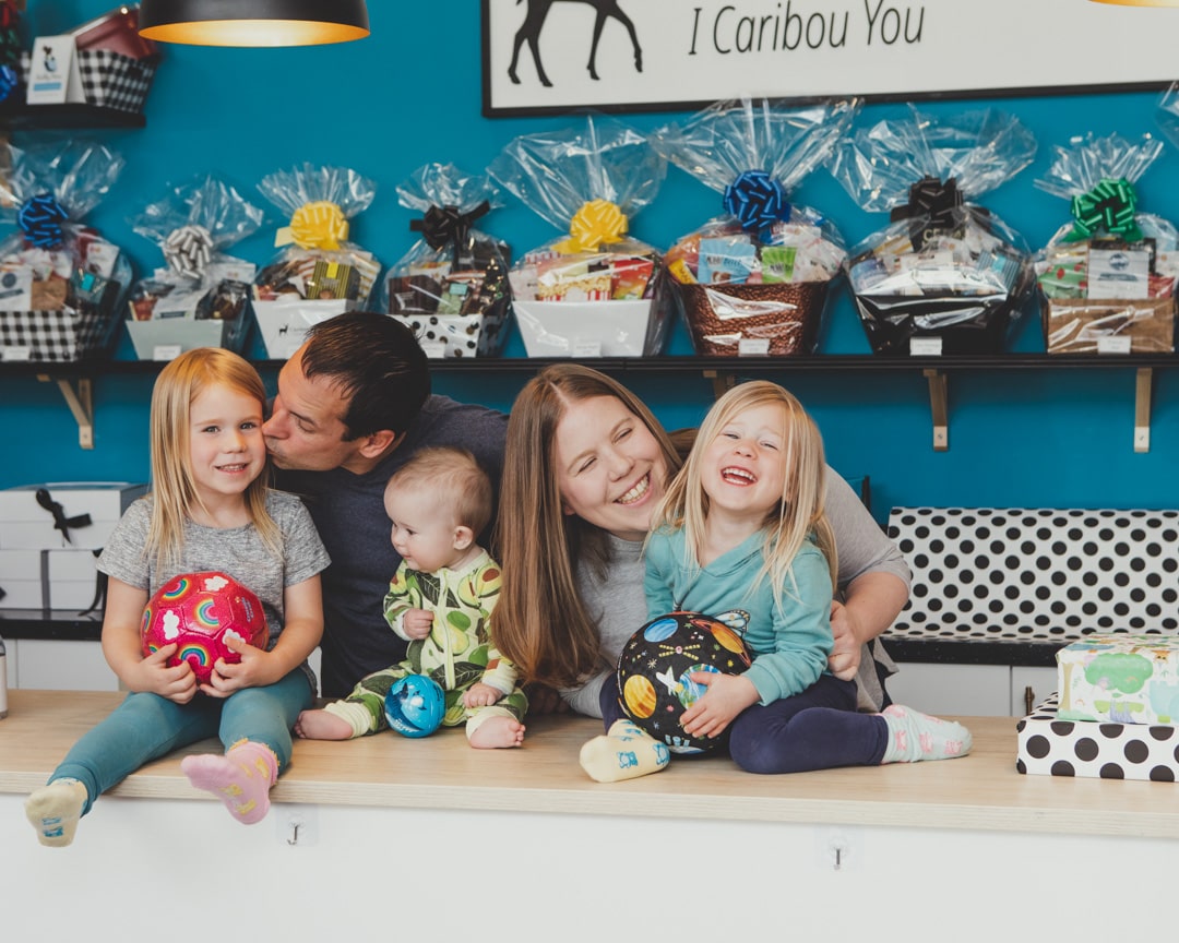 Megan, her husband and three children posing at the counter at the store