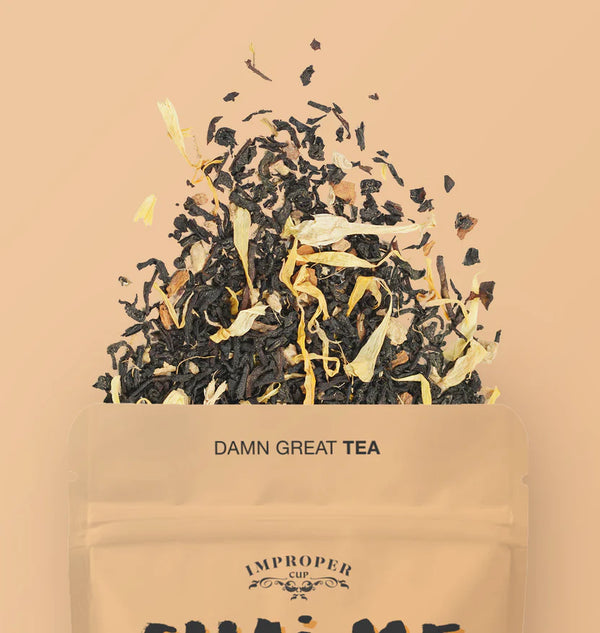 The top quarter of the bag of the visible with a blend of tea leaves spilling out