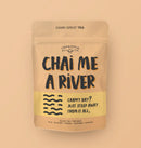 A pink bag with large black text reading "CHAI ME A RIVER" with an illustration of waves below