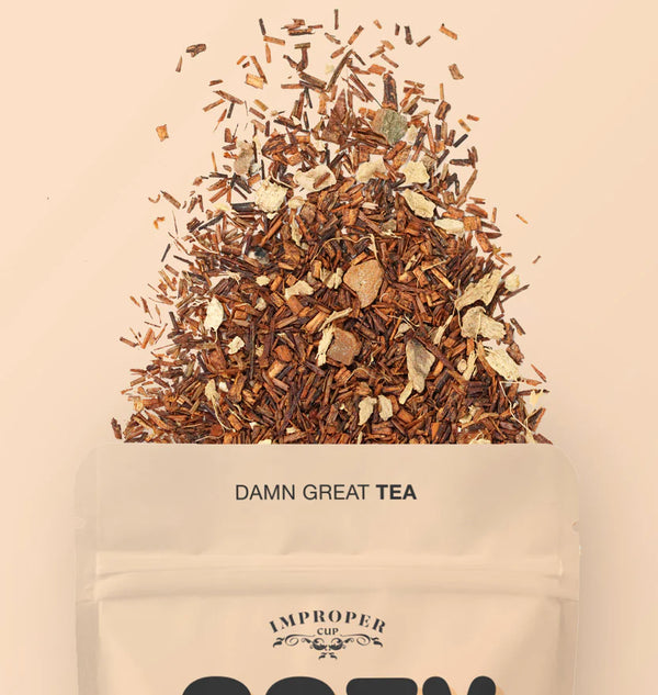 The top quarter of the bag shown with a blend of tea leaves spilling out