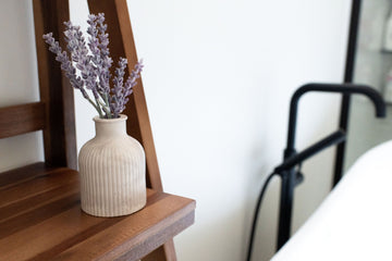 Lynn & Liana Limestone Bud Vase - Small beige limestone bud vase with vertical ridges and narrow neck, holding dried lavender stems.