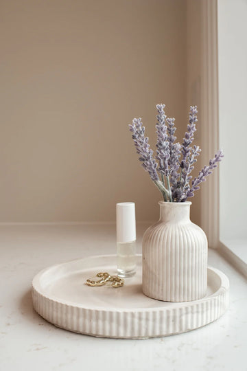 Lynn & Liana Fluted Round Tray - Round fluted ceramic tray in soft cream with textured sides, styled with a ribbed vase and lavender stems.