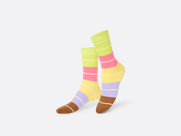 Multicoloured socks with brown toes followed by blue. yellow, pink and lime green sections all containing white stripes