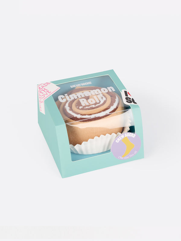A blue box with a clear panel to display brown socks folded to resemble a cinnamon roll with icing