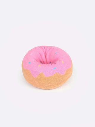 A yellow box with a clear panel displaying socks folded to resemble a pink frosted donut with sprinkles