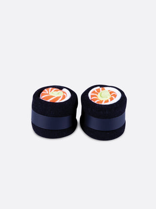 A rectangular pink box with a clear panel in the middle displaying black, white and orange socks rolled to resemble a sushi roll