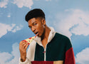 A model looking at the camera pretending to eat the socks shaped like pizza
