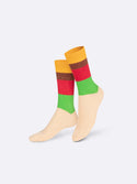 Multicoloured socks with a muted salmon foot, green and red shins followed by a brown section and then a yellow top
