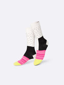 Multicoloured socks with yellow toes, pink and white striped bridge, black and white ankle, white heels, and white and black speckled shins.