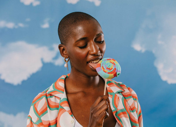 A model pretending to lick the lollipop socks