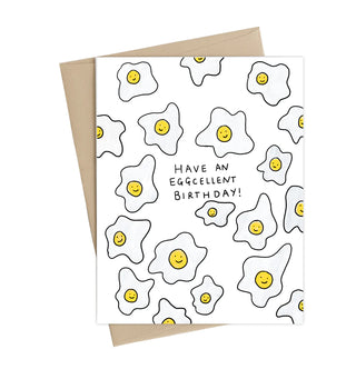 A white card with sunny side up eggs and the words 