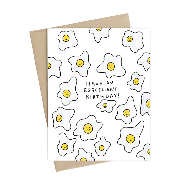 A white card with sunny side up eggs and the words 